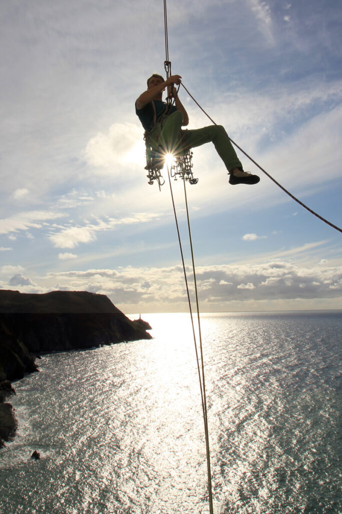 Sea cliff trad climbing courses in Wales, UK. Abseil descent