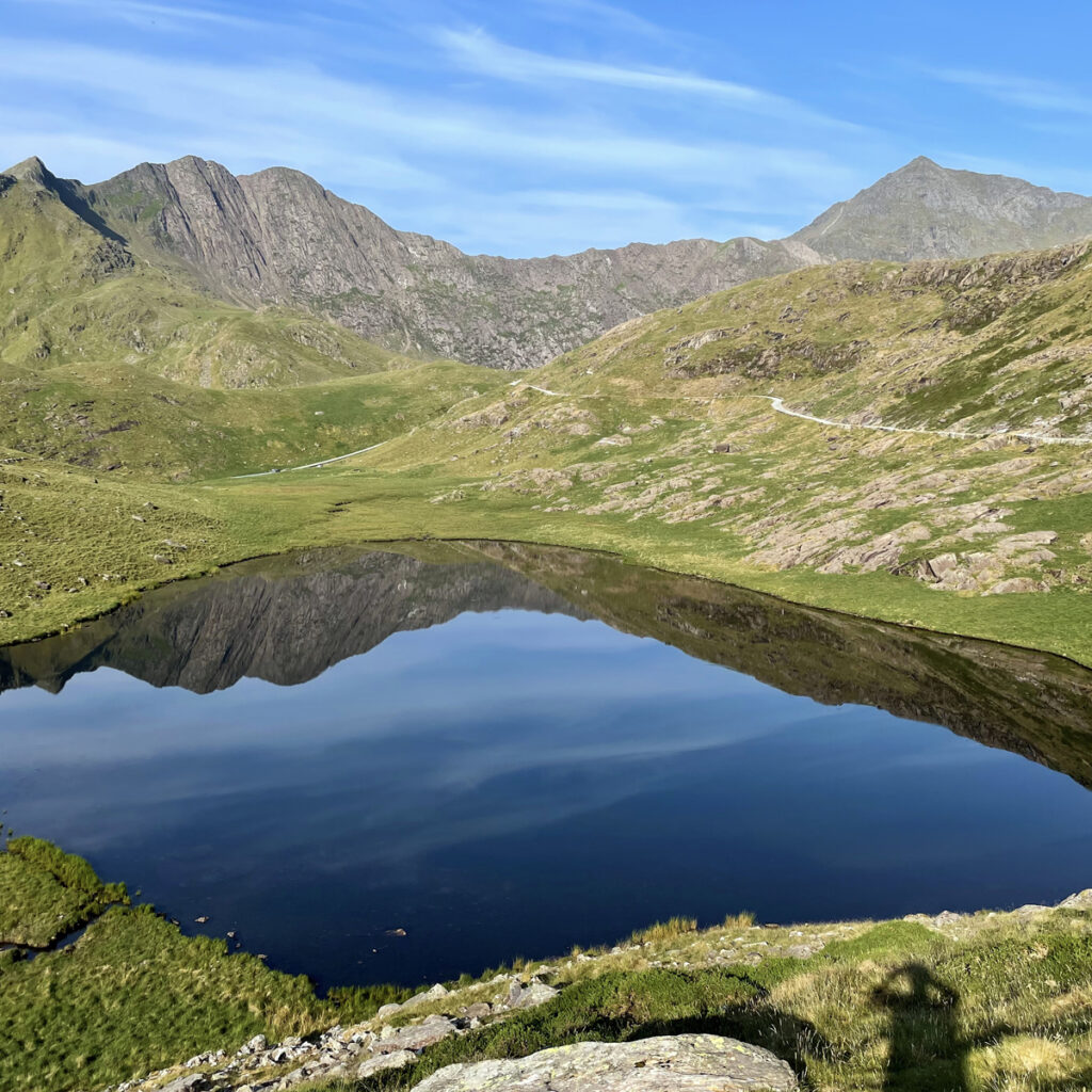 A perfect reflection on Llyn Teyrn underneath Snowdon and Lliwedd